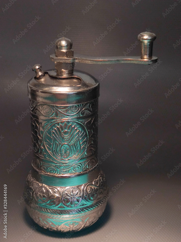 Spice mill on an isolated background. Seasoning with peas.