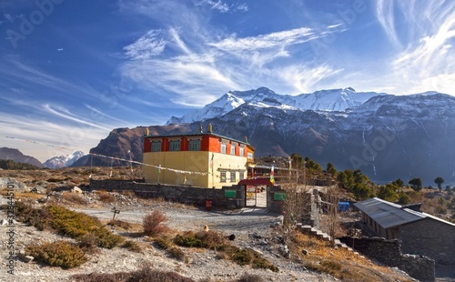 Lophelling Buddhist Monastery Exterior and Distant Snowcapped Annapurna Range Mountain Peaks Landscape View in Nepal Himalayas