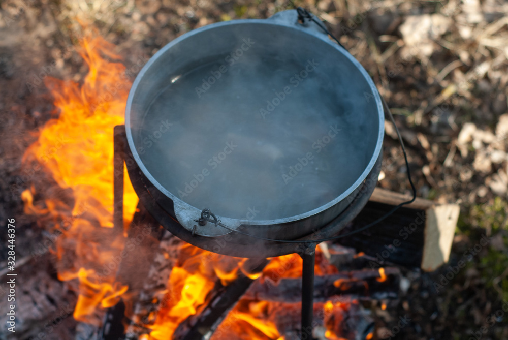 The cauldron on the fire the view from the top, boiling water in the pot, The cauldron on the fire the view from the top, boiling water in the pot,