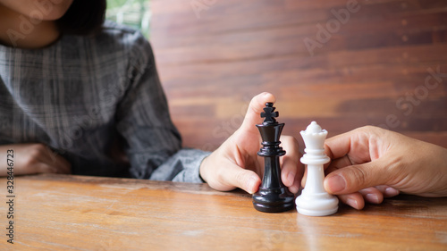 Tow business women play chess game. Demonstrate competition to success playing, the business strategy.