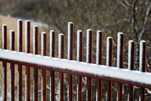 Snowy wooden railing in winter.