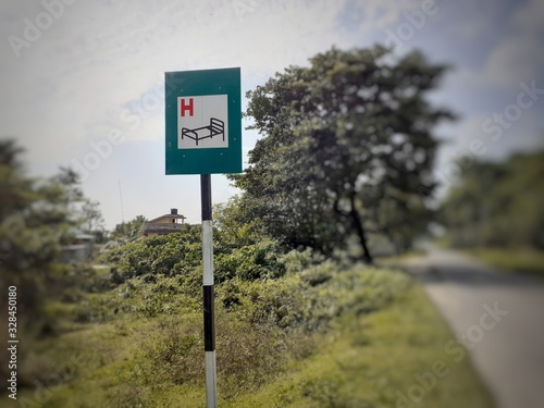 Rectangular green color hospital sign near the street