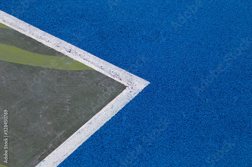 Sports court or playground background. Artificial rubber coating for playgrounds and sports places in blue color