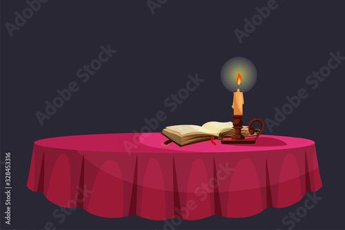 Table with burning candle, book on dark background