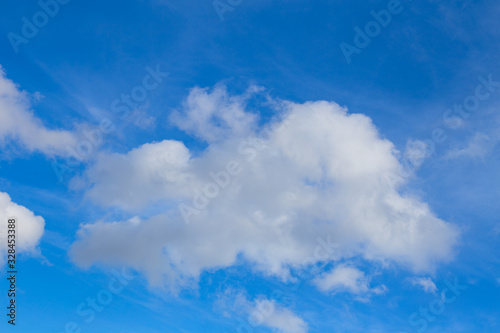 Bright white cloud on a blue sky. Background with place for text.