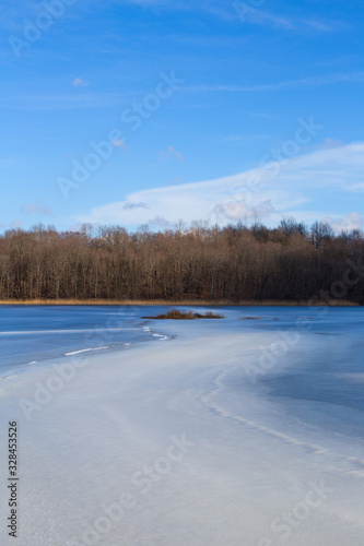 Frozen lake. Landscape of a winter lake. Vertical background © lexashka