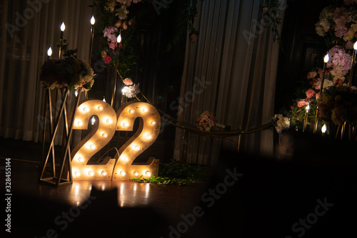 Happy 22 years old celebration. Numbers 22 carved from wood with light. Interior decoration for a birthday
