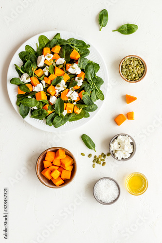 Cooking salad with pumpkin and basil. Ingredients on white background top-down © 9dreamstudio