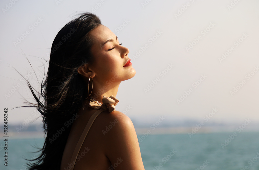 Beautiful Asia woman sexy and smile portrait on beach and soft sunrise on face. Beautiful Asia woman sexy and smile portrait on beach and soft sunrise on face.