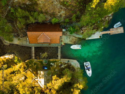 Norwegian hytte and boats on fjord shore, aerial view photo