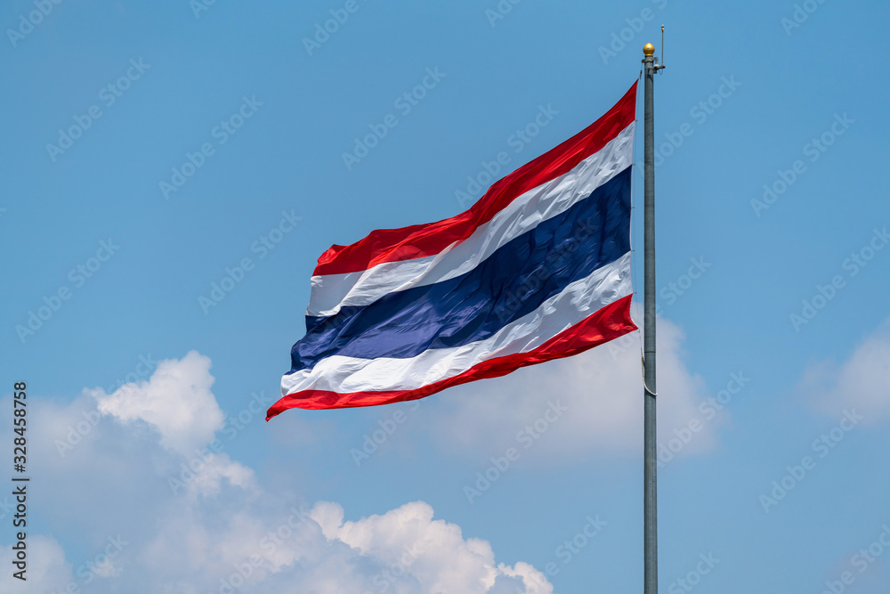 National flag of Thailand with blue sky.