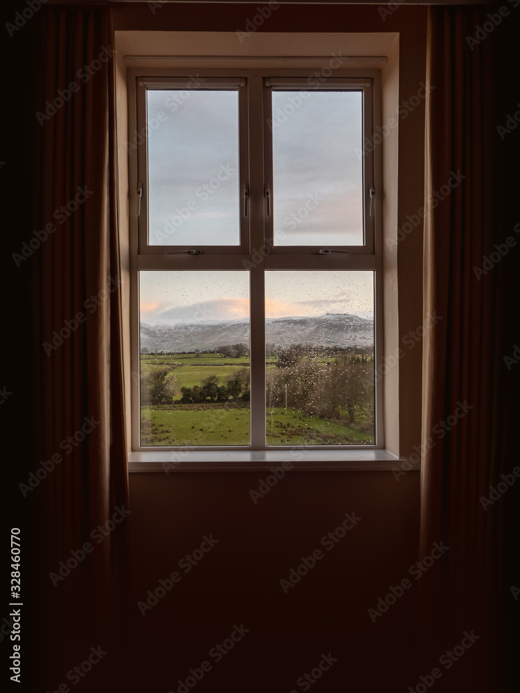 Window in a house with beautiful view on a mountains. Concept high end accommodation.