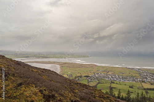 View from Knocknarea hill on Atlantic ocean and Strandhilll town. Low storm clouds over ocean.