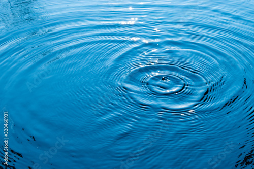 Blue water surface.Top view Closeup blue water rings, Circle reflections in pool.