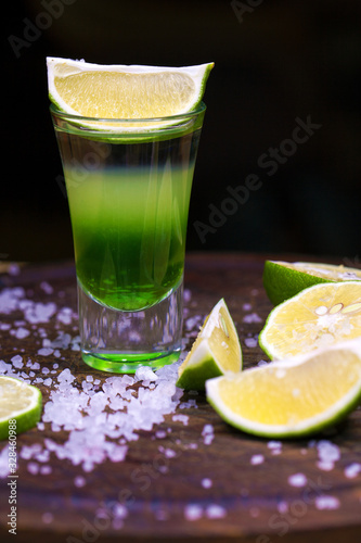 Alcohol cocktail with tequila and slice of lime