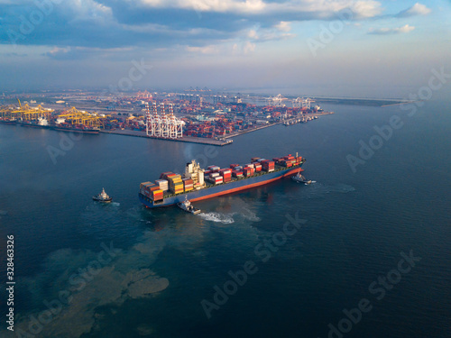 Aerial view from drone, Cargo vessel in beautiful scenic sky. Professional business logistics and transportation of cargo ship.