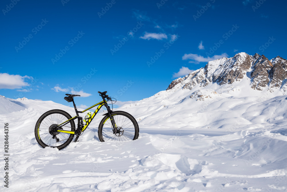 Mountain biking in the snow in the high mountains
