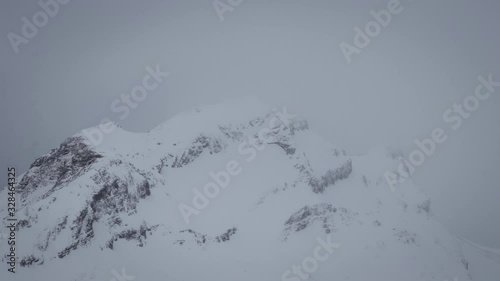 Cloudy Snow Capped Swiss Mountain Peak photo