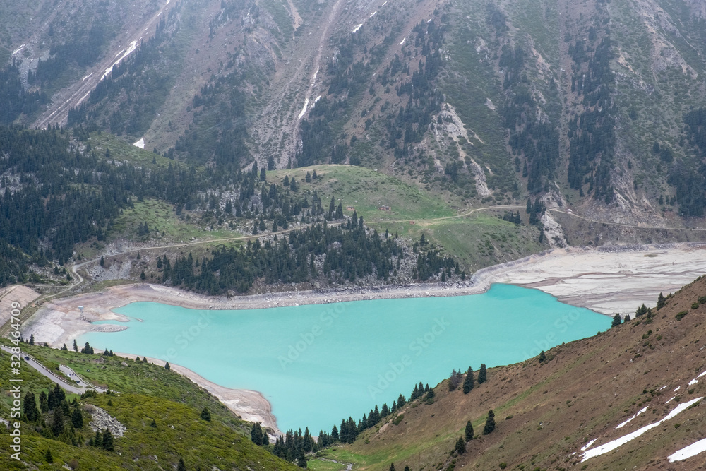 Beautiful landscape of blue lake in the mountains. Big Almaty Lake in the spring.