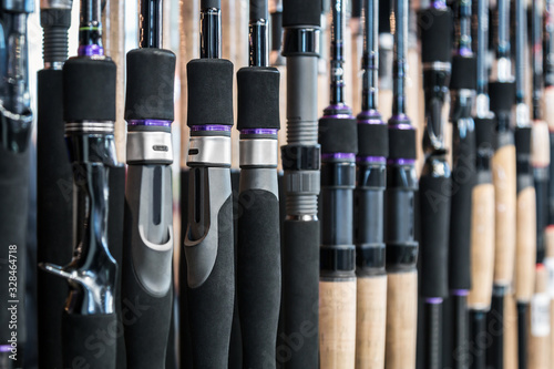 different rods and spinning rods for fishing on the counter in the store. Shallow depth of field