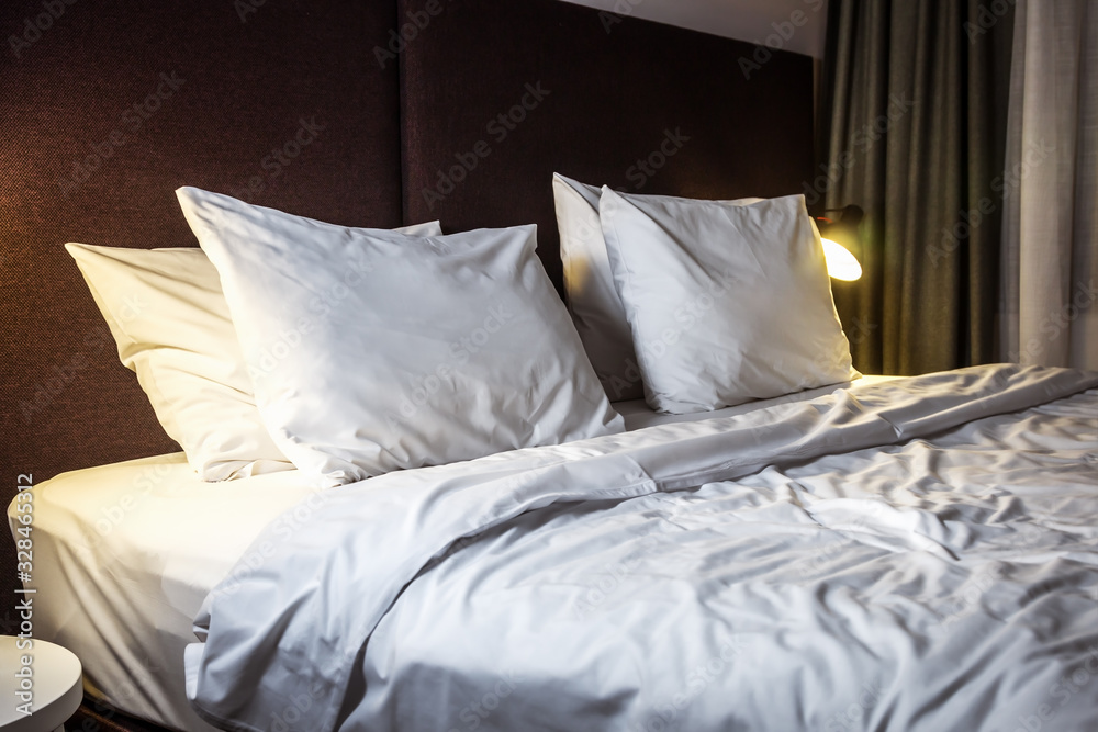 large bed with pillows in the hotel or at home. Concept on preparation of the bed in a hotel room or at home large bed with pillows in the hotel or at home. Concept on preparation of the bed in a hotel room or at home