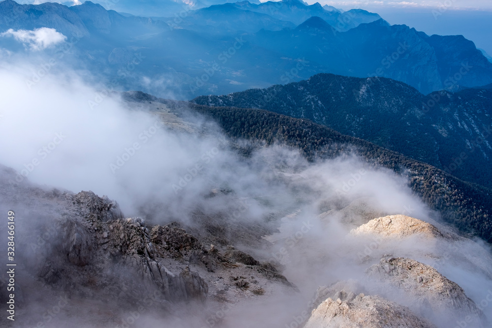Beautiful view to Western Taurus mountain range with cloudy sky, captured from Tahtali mountain's peak.