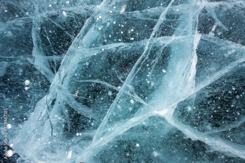 Cracks in the ice with frosted air bubbles inside.