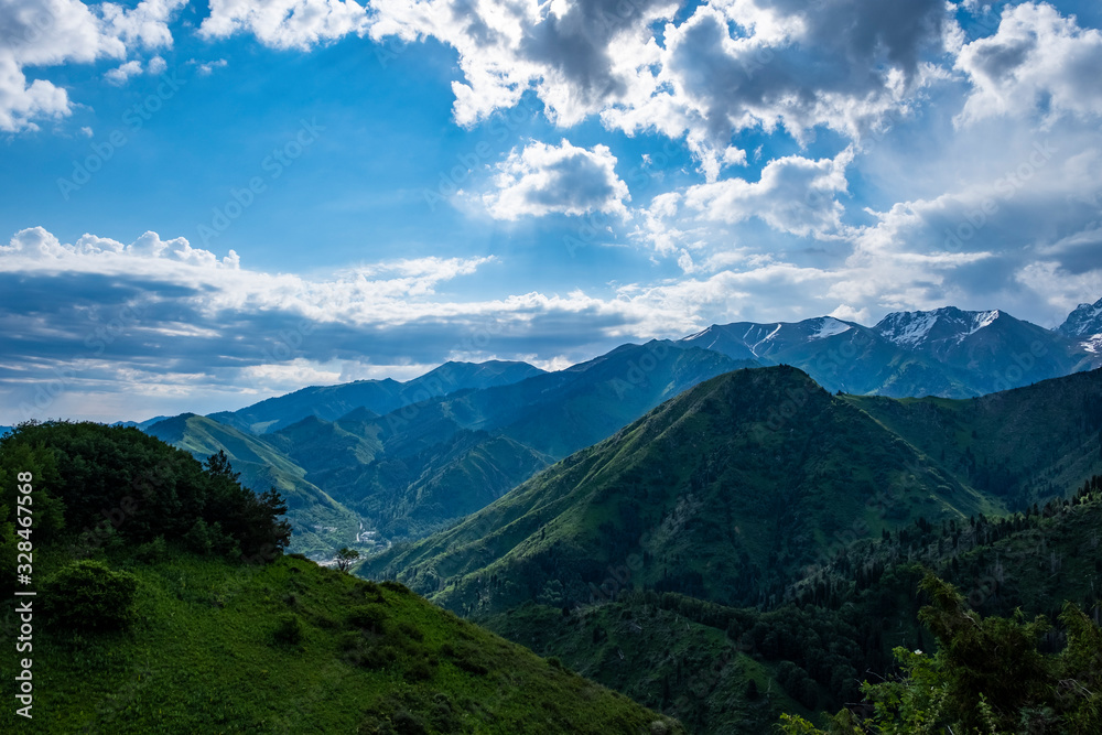 Almaty mountains with cloudy stormy clouds. Overcast - weather storm. Rain in mountains. - obrazy, fototapety, plakaty 