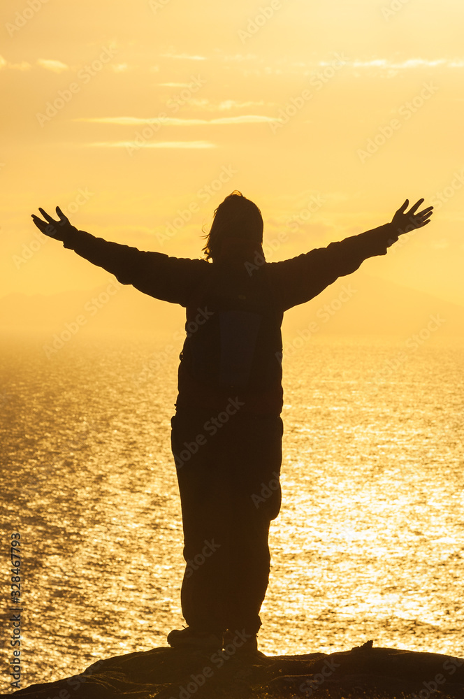 Silhouette woman hiker on top of mountain