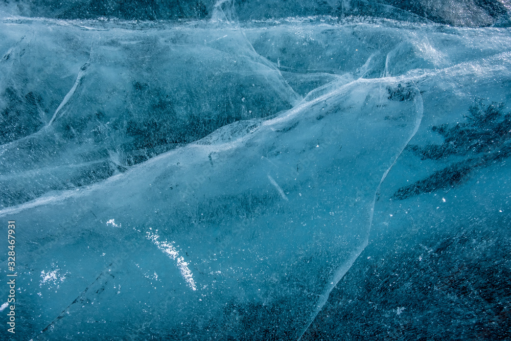 Fototapeta premium Cracks in the ice. Frozen lake surface. Cracked ice.