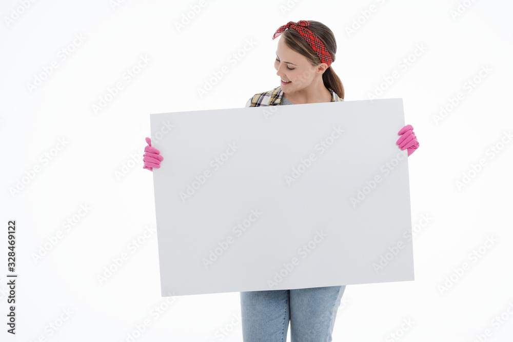 Portrait of happy female doing house duties wearing rubber gloves and holding cleaning equipment. Cheerful look. Hygiene, cleaning service concept. Isolated picture. White background. Portrait of happy female doing house duties wearing rubber gloves and holding cleaning equipment. Cheerful look. Hygiene, cleaning service concept. Isolated picture. White background.