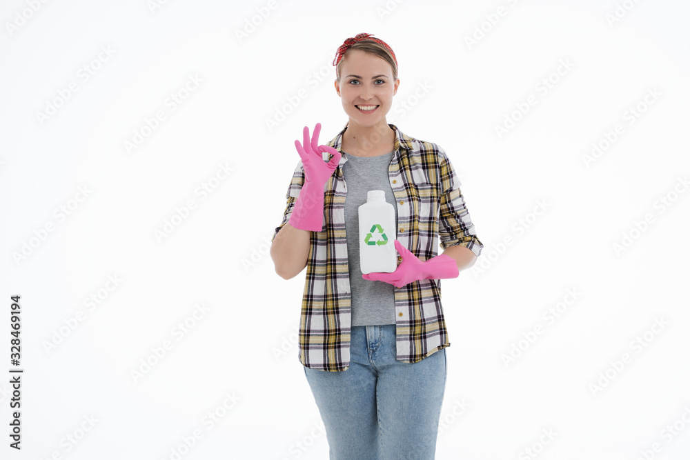 Portrait of happy female doing house duties wearing rubber gloves and holding cleaning equipment. Cheerful look. Hygiene, cleaning service concept. Isolated picture. White background.