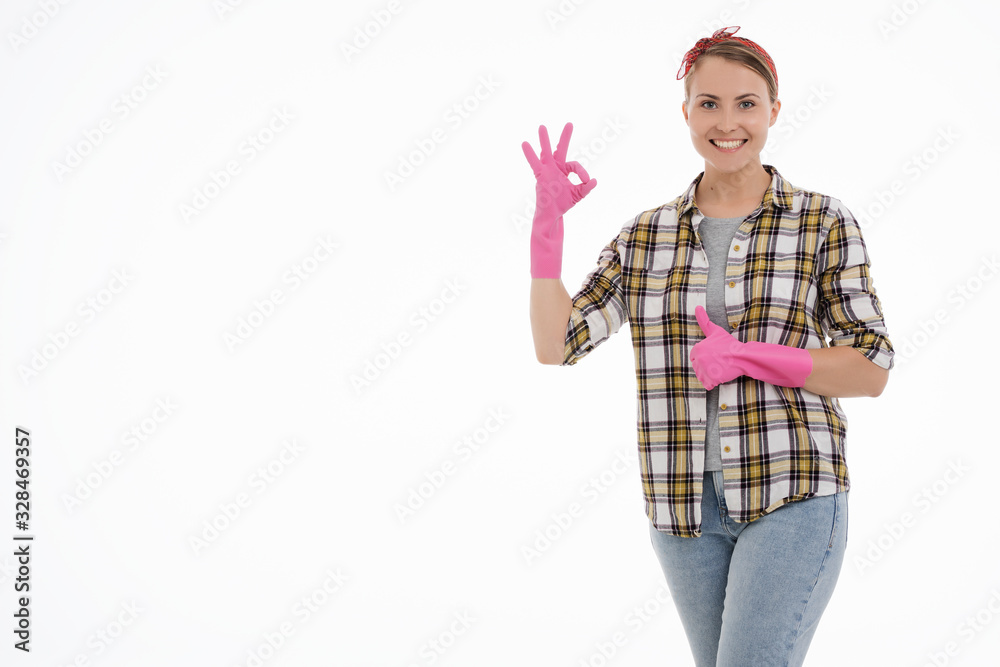 Portrait of happy female doing house duties wearing rubber gloves and holding cleaning equipment. Cheerful look. Hygiene, cleaning service concept. Isolated picture. White background. Portrait of happy female doing house duties wearing rubber gloves and holding cleaning equipment. Cheerful look. Hygiene, cleaning service concept. Isolated picture. White background.