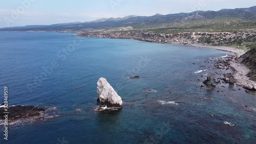 Beautiful scenic aerial over the rocky coast and turquoise seas on Greece. Wide drone shot over Karavopetres Akamas, Cyprus. photo