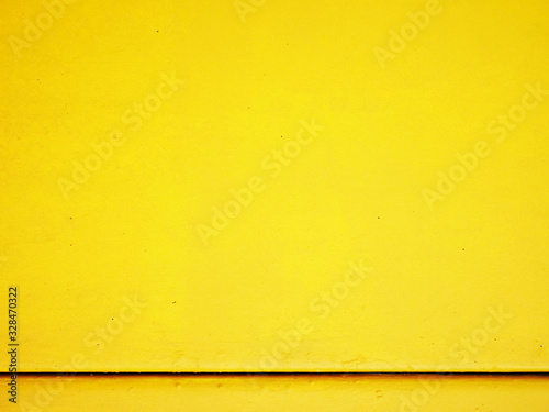 Yellow cement wall background.