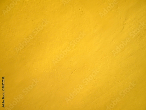 Yellow cement wall background.