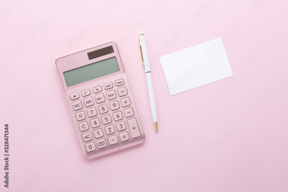 Pink gold calculator with pen and business card on pink background, top view Pink gold calculator with pen and business card on pink background, top view