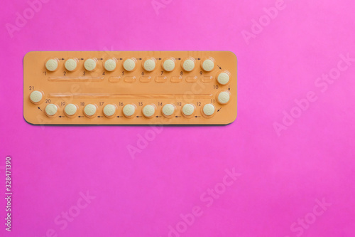 Contraception pills on pink background. Female contraceptives concept. Bitrh control concept.