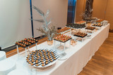 White table with diverse appetizers and tableware served by catering company