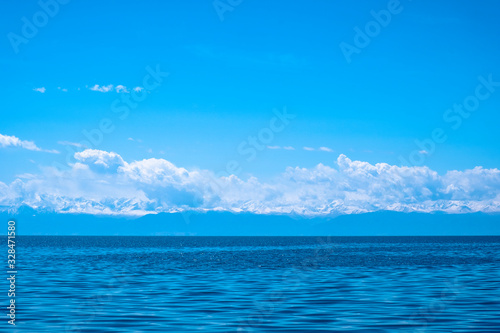 Sunset on Issyk-kol lake, Kyrgyzstan. Lake in the mountains. Lake with mountains background. Toned.