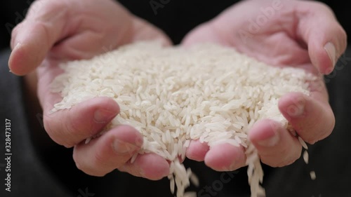 Rice Falling From Old Man Hands, Close Up, Slow Motion photo
