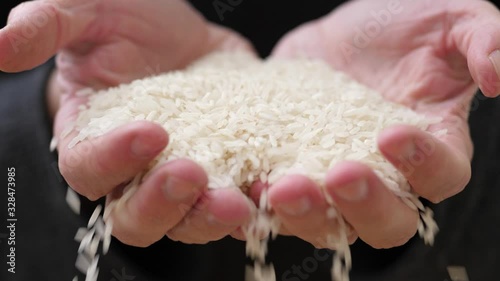 Rice Falling From Old Man Hands, Close Up, Slow Motion photo