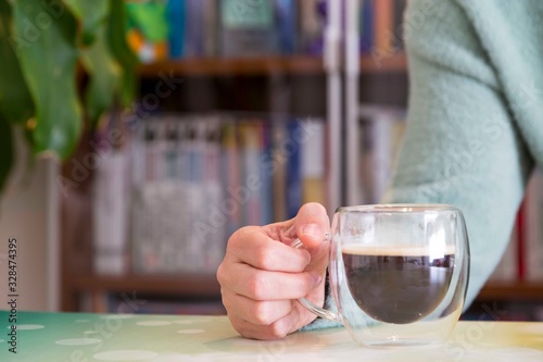 Transparent double wall glass mug with espresso coffee  at home at work