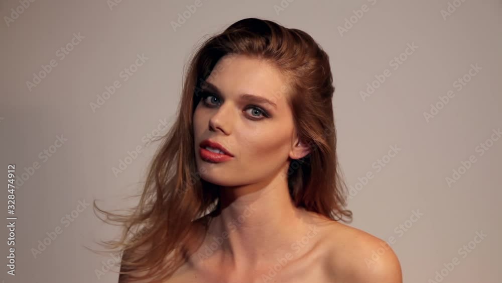 beautiful girl with nice make up shaking her hair and looking at camera close up. beautiful girl with nice make up shaking her hair and looking at camera close up.