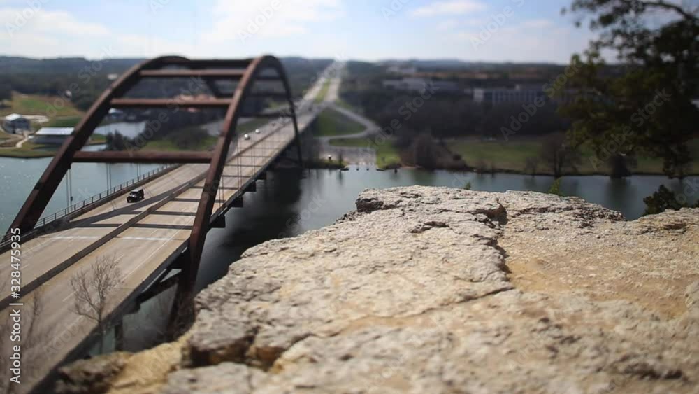 Austin Pennybacker Bridge, focus isolates section of ledge and front part of the bridge. Traffic backed up all the way across the bridge, speed slows to real time and then speeds back up.