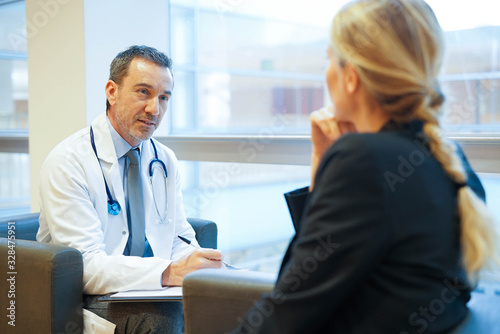 Specialist with patient in doctor's office