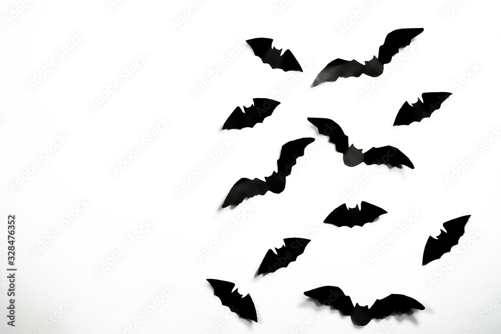 Halloween paper decorations concept. Black paper bats on a white background. Halloween concept. Halloween paper decorations concept. Black paper bats on a white background. Halloween concept.