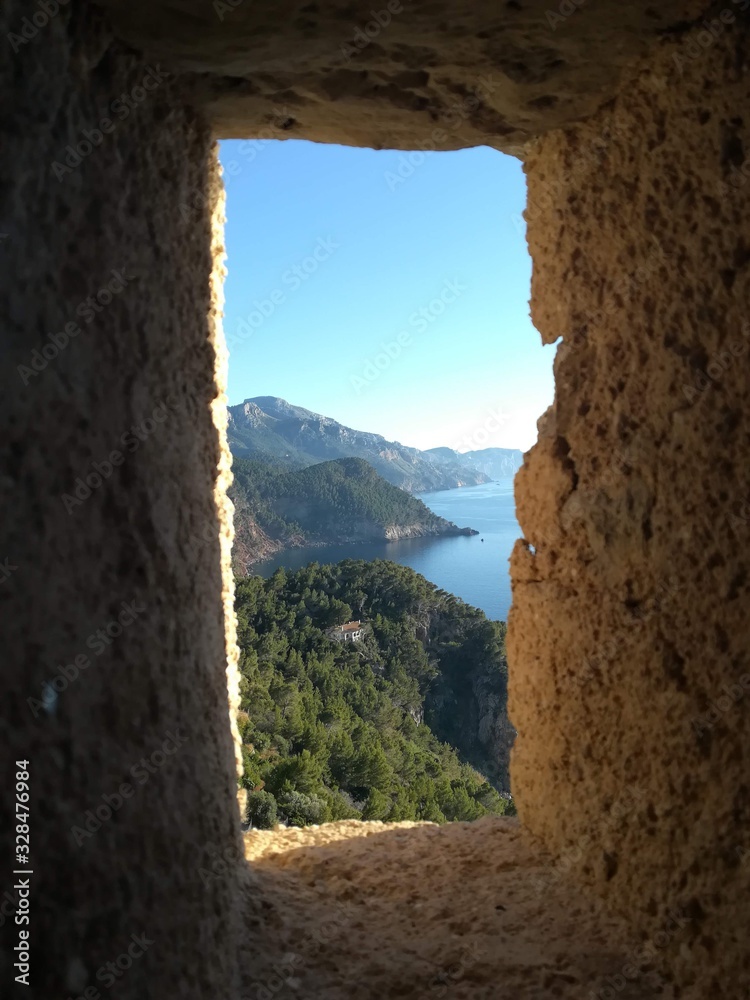 Window facing the mountains next to the sea at Banyalbufar,Mallorca Island.