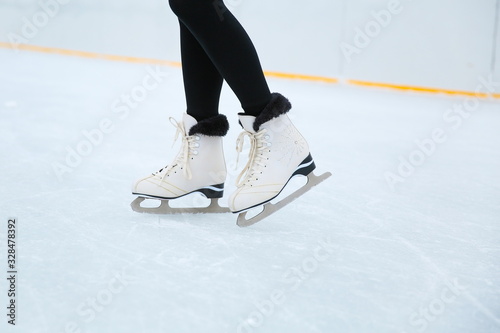 woman is ice skating on rink close up