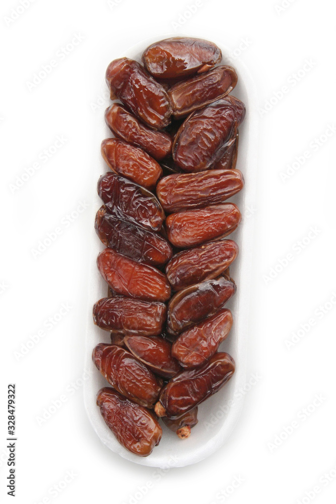 Obraz premium Dried dates ina plastic bowl isolated on white background. Date fruits on white
